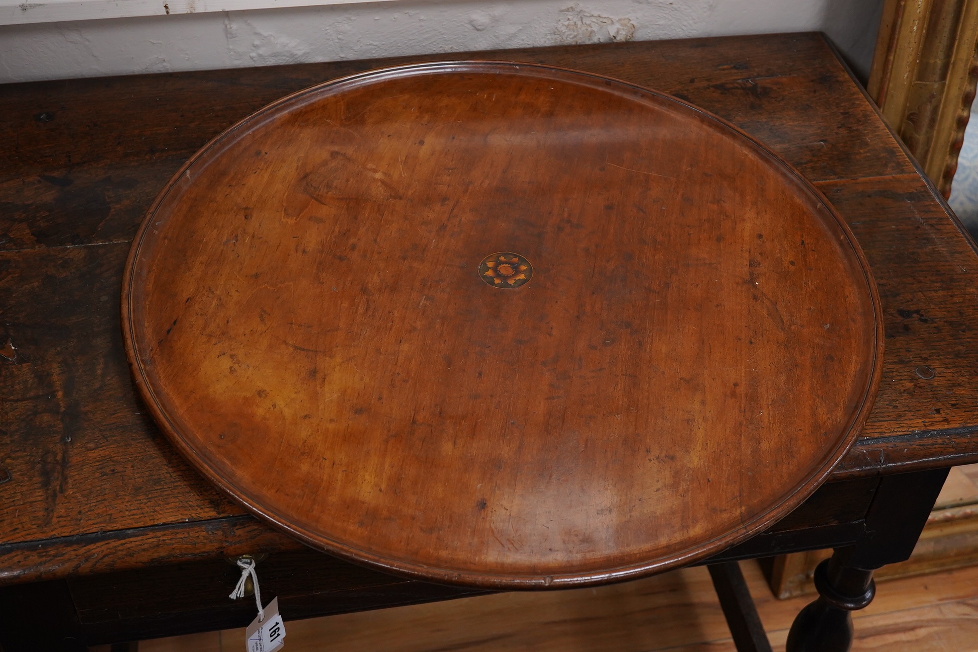 Three various mahogany trays including an Edwardian inlaid and galleried example, largest 61cm wide. Condition - fair